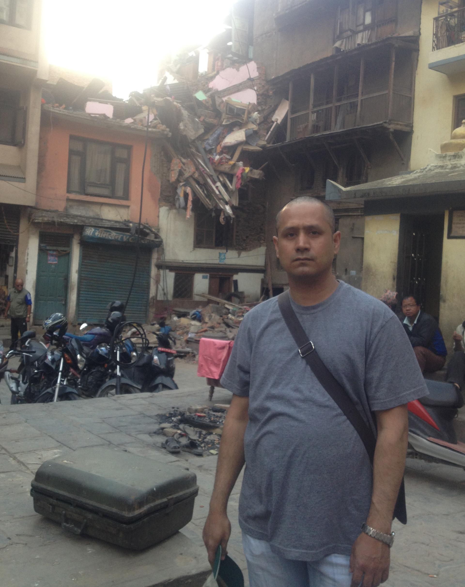 Rajesh Shrestha stands in front of his home in Nepal in March of this year.