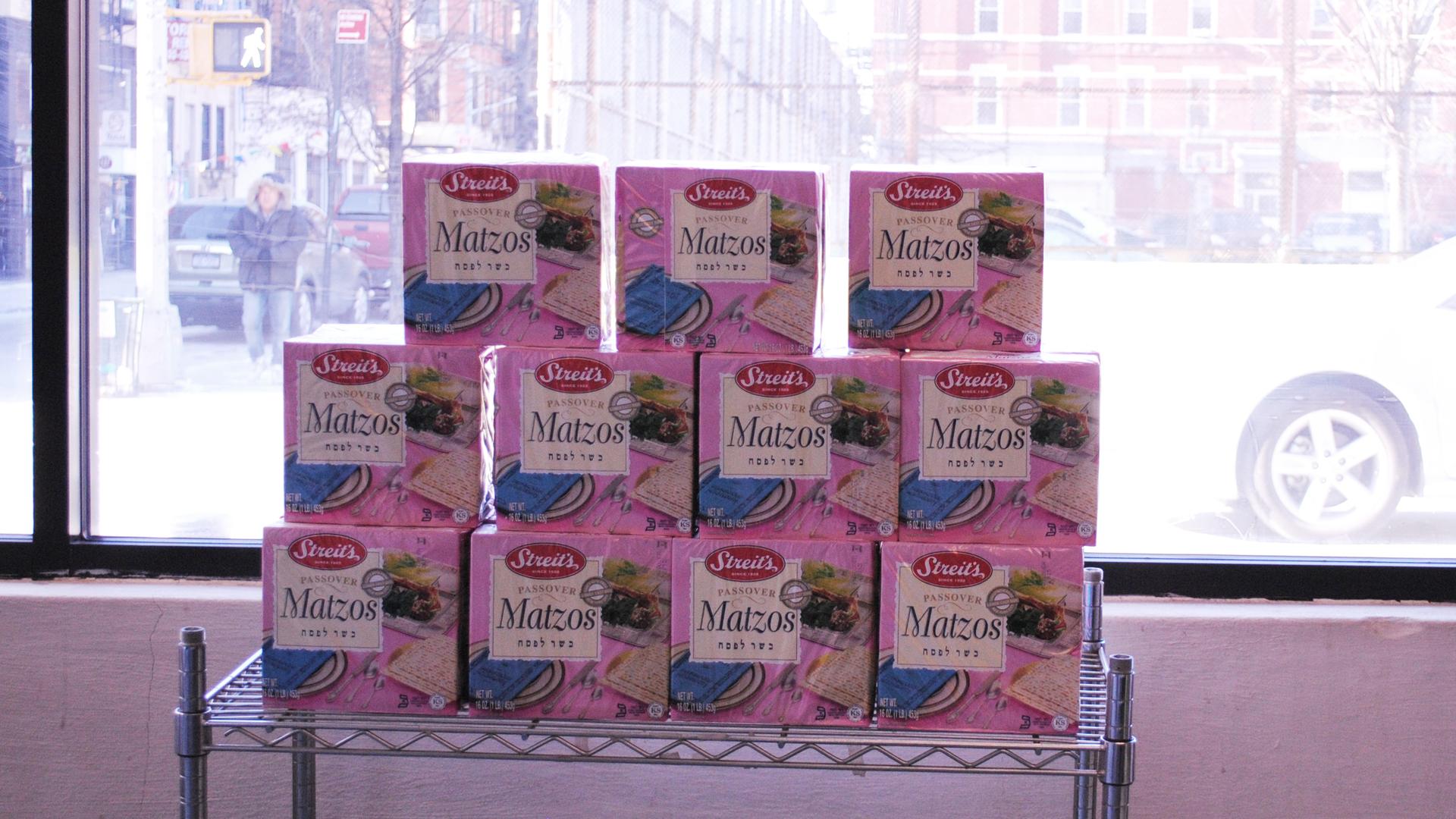 Streit's storefront with boxes of matzo in the signature pink box.