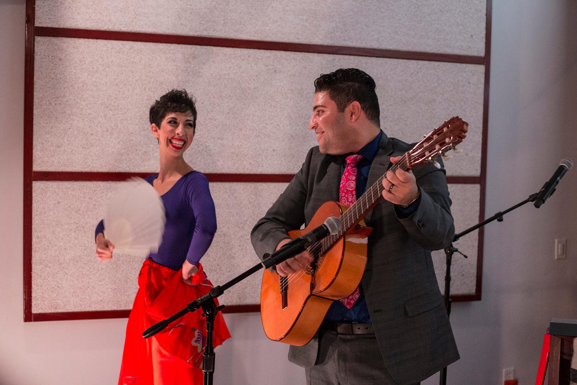 Omar locks eyes with his wife, Jasmín, on stage as violinist Patrick Contreras makes his way offstage and into the crowd during the final number of their performance.