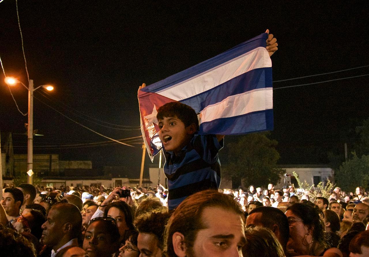 A child waves a Cuban flag at a 