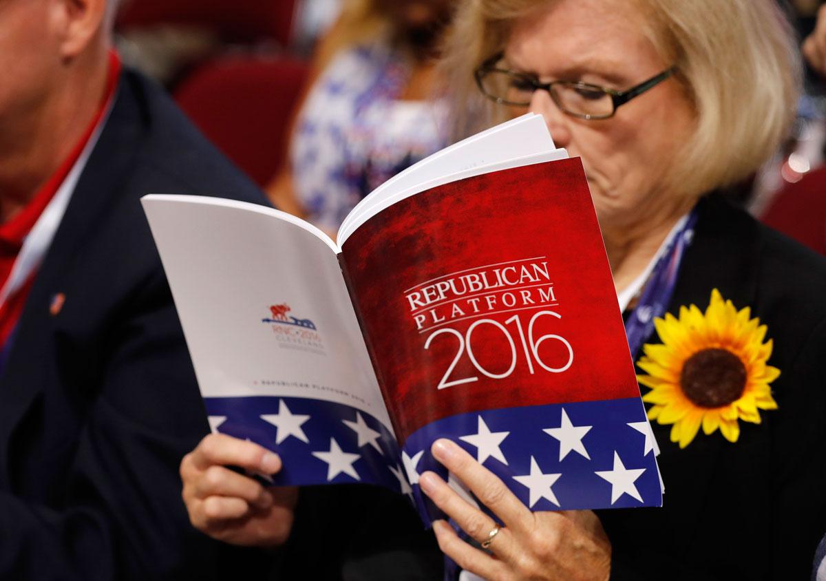 A delegate studies a copy of the Republican platform document that reflect the policies of the Republican Party that will be voted on at the RNC.