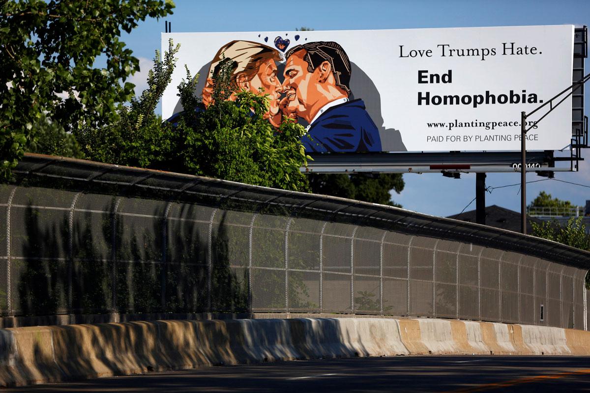 A billboard erected in advance of the RNC depicts Donald Trump kissing former presidential candidate Sen. Ted Cruz.