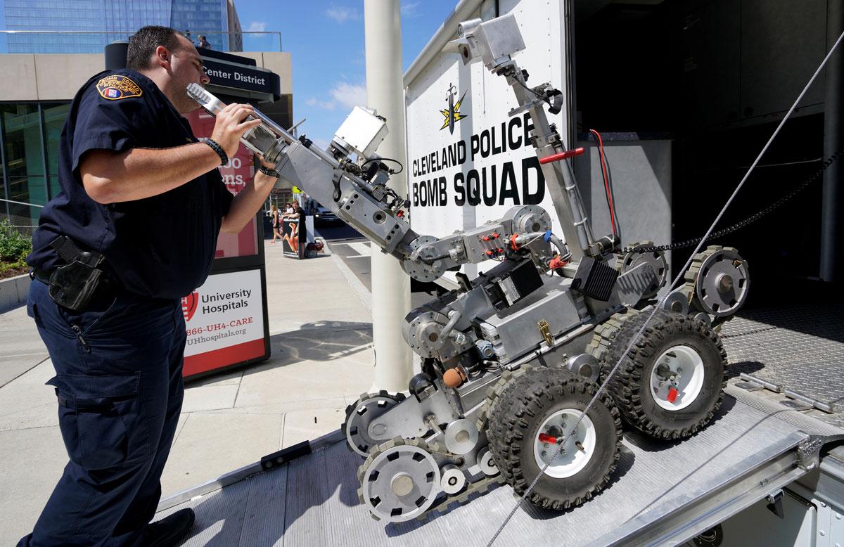 A Cleveland police bomb squad technician loads a Remotec F5A explosive ordnance device robot during a demonstration of police capabilities near the site of the RNC.
