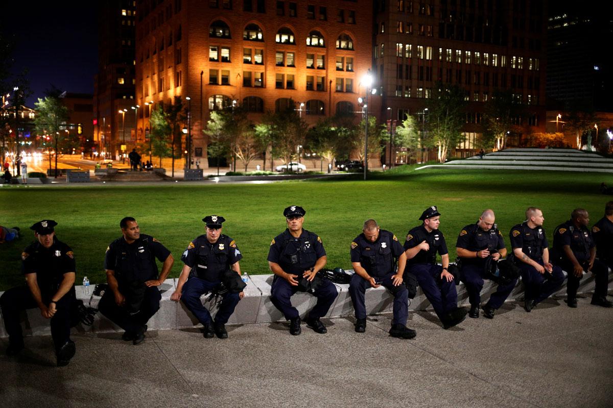 Cleveland Police officers rest in Public Square park after the end of speeches at the RNC.