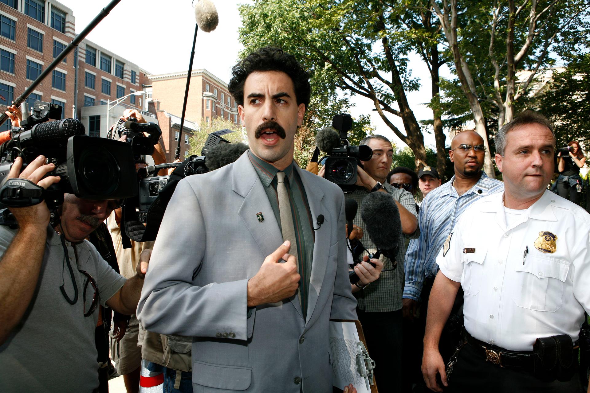 Actor Sacha Baron Cohen (C) in the role of fictitious Kazakh journalist Borat Sagdiyev is turned away from the Kazakh Embassy in Washington, September 28, 2006.