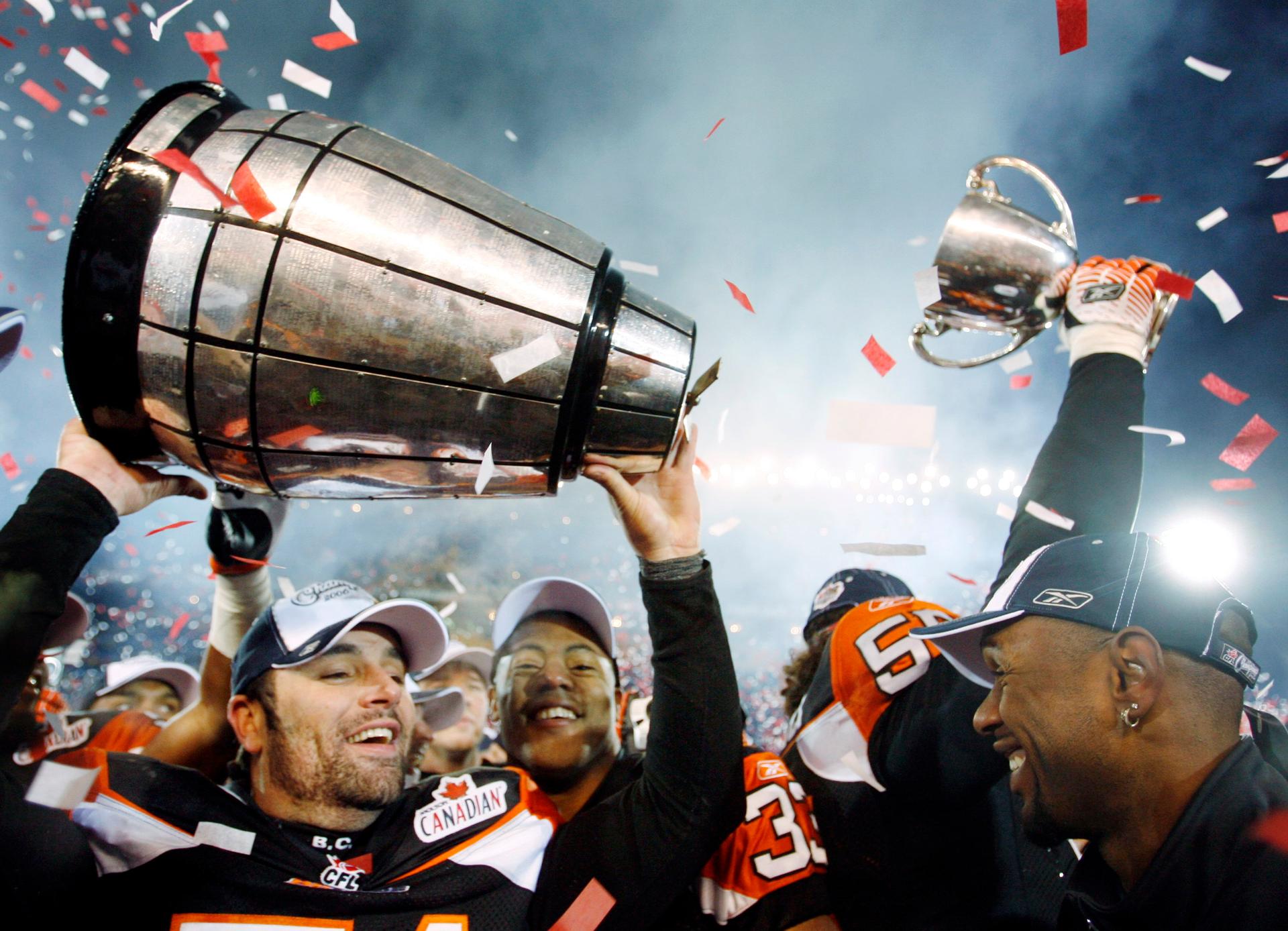 B.C. Lions players celebrate with the Grey Cup, in two pieces, after beating the Montreal Alouettes to win the Canadian Football League's 94th Grey Cup in Winnipeg November 19, 2006.