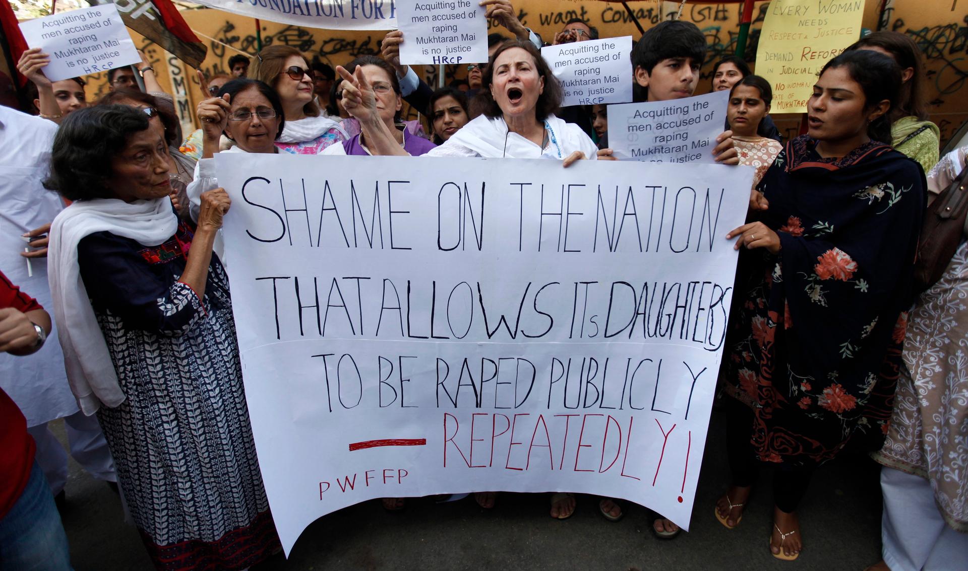 Activists hold a banner during a protest rally against a court decision involving Mukhtaran Mai, a victim of a village council-sanctioned gang-rape, in Karachi, Pakistan April 23, 2011.