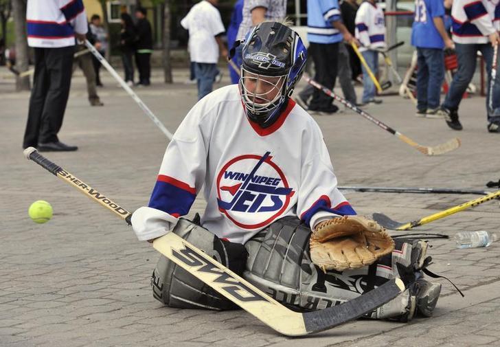 Cullen Driedger, 9, plays street hockey in Winnipeg, Manitoba May, 2011.