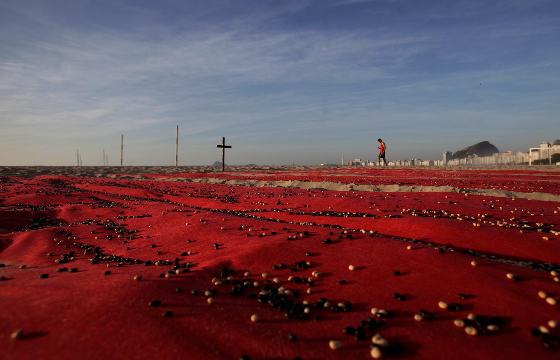 To raise awareness of the higher murder rate in Brazil, the non-governmental group Rio de Paz placed about 500,000 beans over red sheets to represent the number of people killed over the the previous 10 years in Brazil. Photo taken in Rio de Janeiro, Dec.
