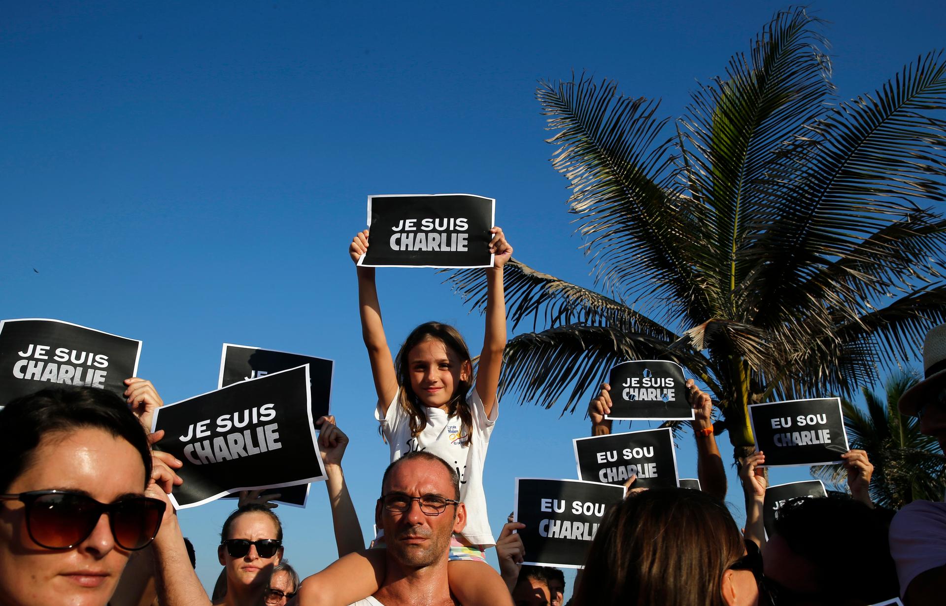 Brazilians and tourists gather before Arapador Beach in Rio de Janeiro to support Charlie Hebdo.