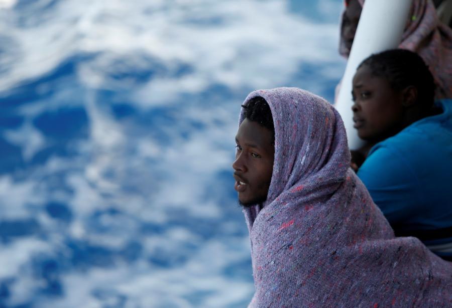 Migrants look out toward the Maltese island of Gozo, as the boat the Phoenix makes its way toward Italy after rescue operations off the coast of Libya, on May 5.