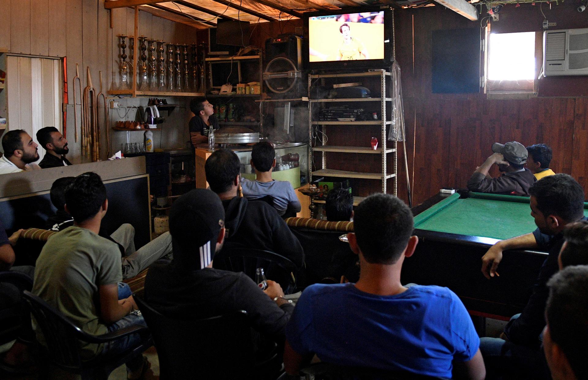 Syrians watch the World Cup 2018 qualifier between Australia and Syria inside a refugee camp in Bar Elias, in the Bekaa Valley, Lebanon, Oct. 10, 2017.