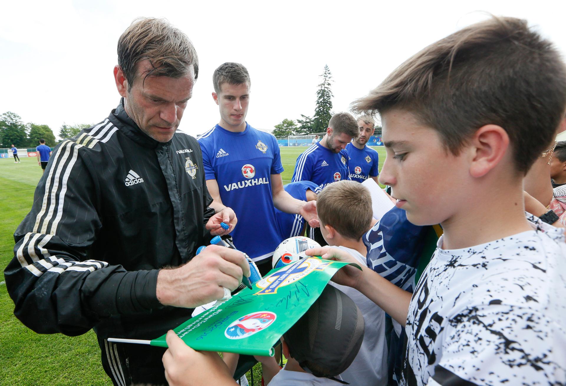 Northern Ireland's players sign autographs after second public training at Parc Montchervet, Saint-Georges-de-Reneins on June 7.