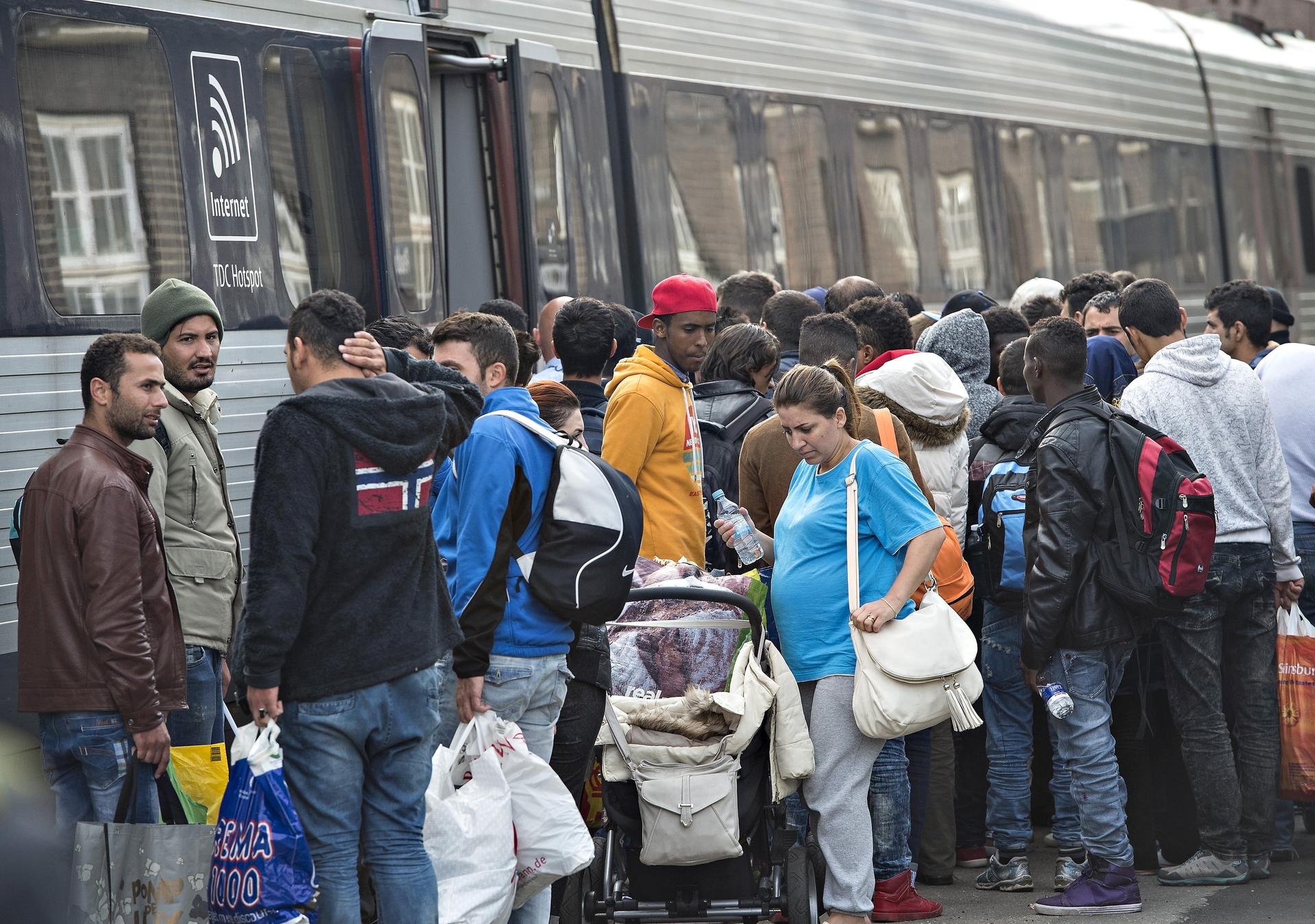 Migrants, mainly from Syria, prepare to board a train headed for Sweden, at Padborg station in southern Denmark, Sept. 10, 2015.
