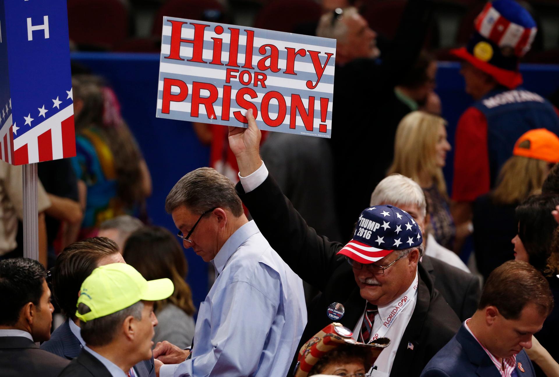 A supporter of Republican U.S. presidential candidate Donald Trump holds up a sign during the first day of the Republican National Convention in Cleveland, Ohio, U.S., July 18, 2016.