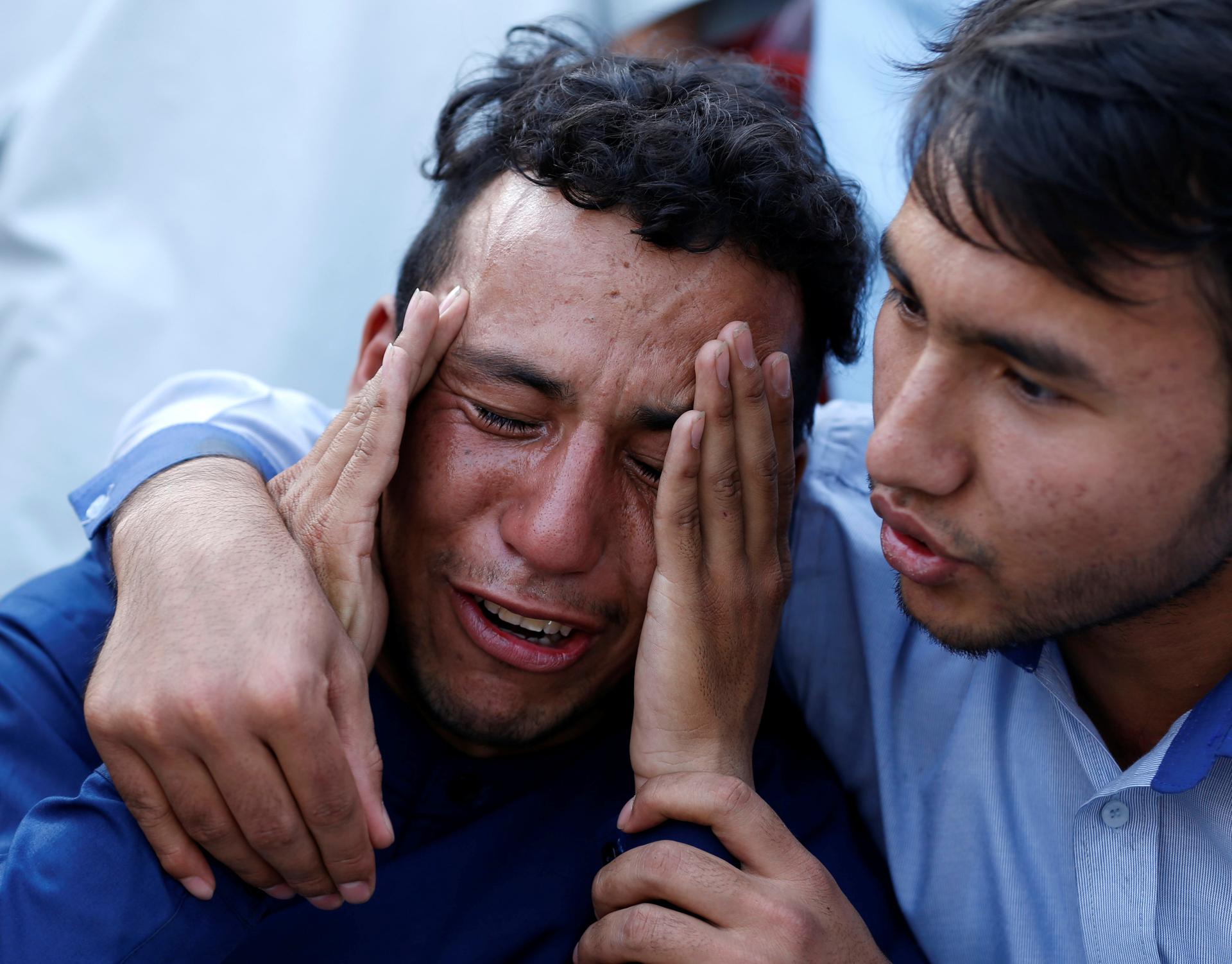 An Afghan man weeps outside a hospital after a suicide attack in Kabul, Afghanistan July 23, 2016.