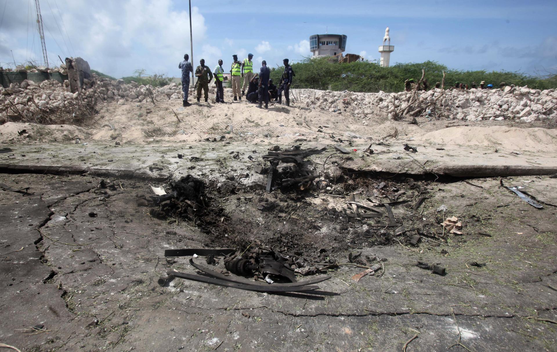 Somali policemen and miltary gather near the scene of a suicide bombing near the African Union's main peacekeeping base in Mogadishu, Somalia, July 26, 2016.