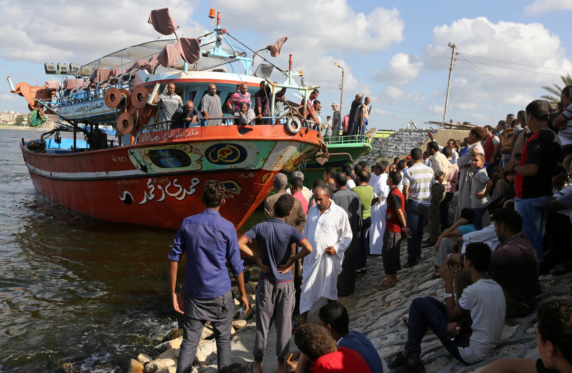 People gather along the shore of the Mediterranean Sea during a search for victims after a migrant boat capsized, in Al-Beheira, Egypt, September 22, 2016.