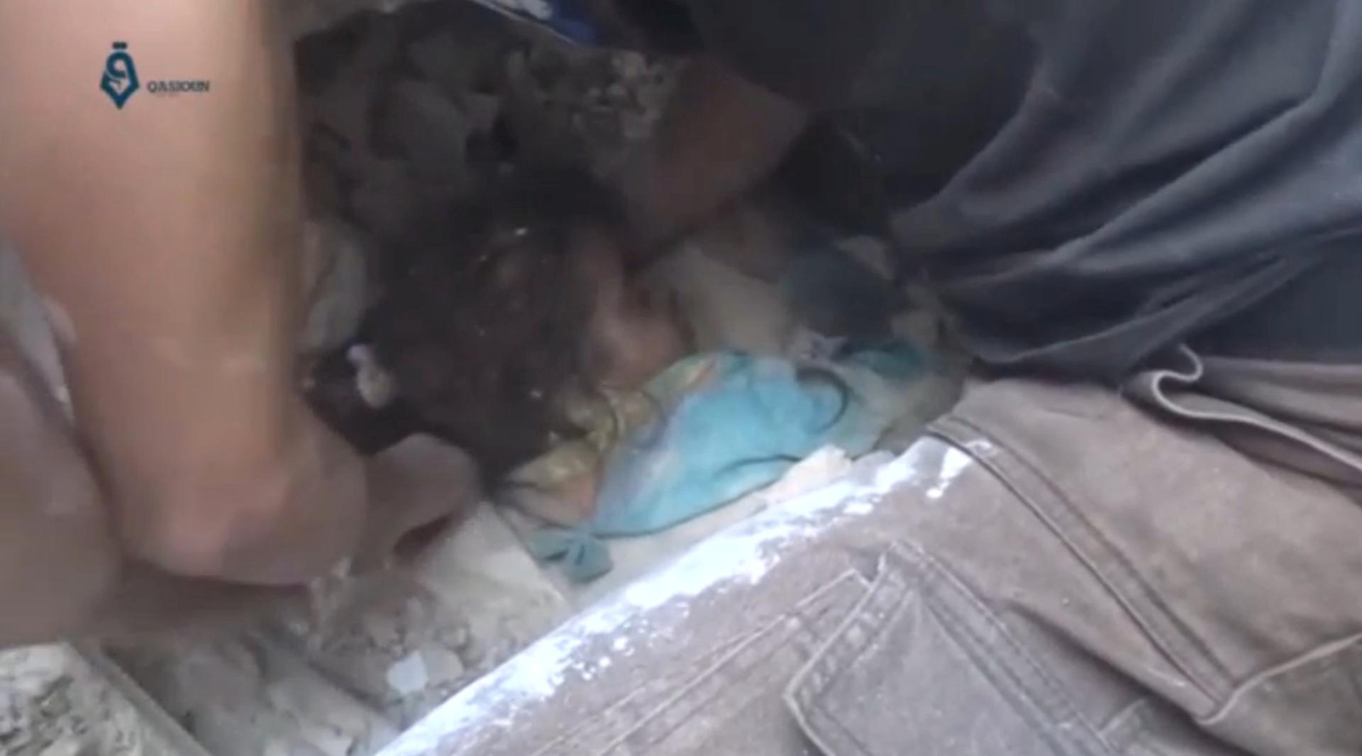 A still image from video posted on social media web sites shows a child being rescued from rubble of a collapsed building in Aleppo, Syria.
