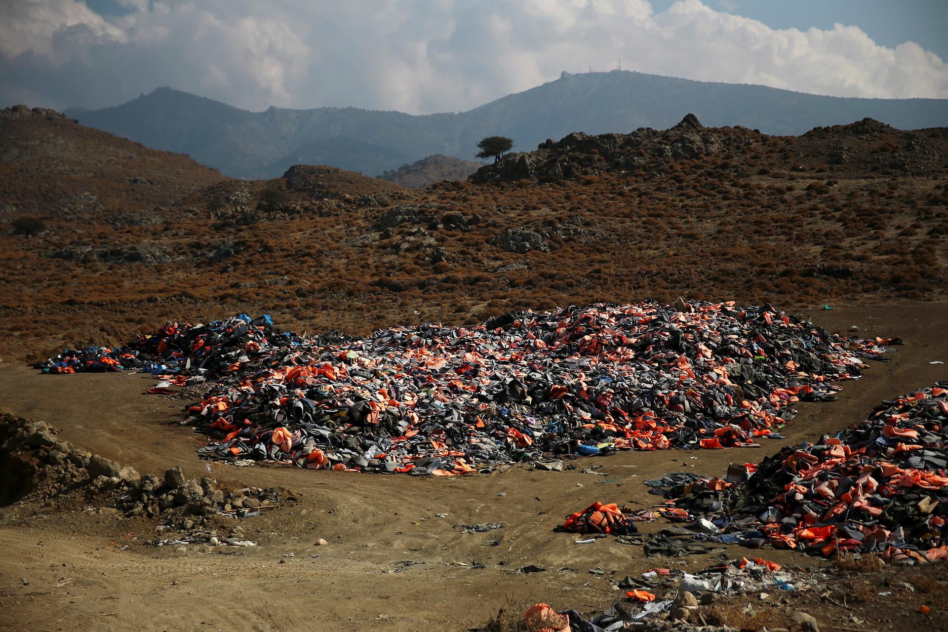 Thousands of lifejackets left by migrants and refugees are piled up at a garbage dump site near the town of Molyvos on Lesbos, Oct. 5, 2016.