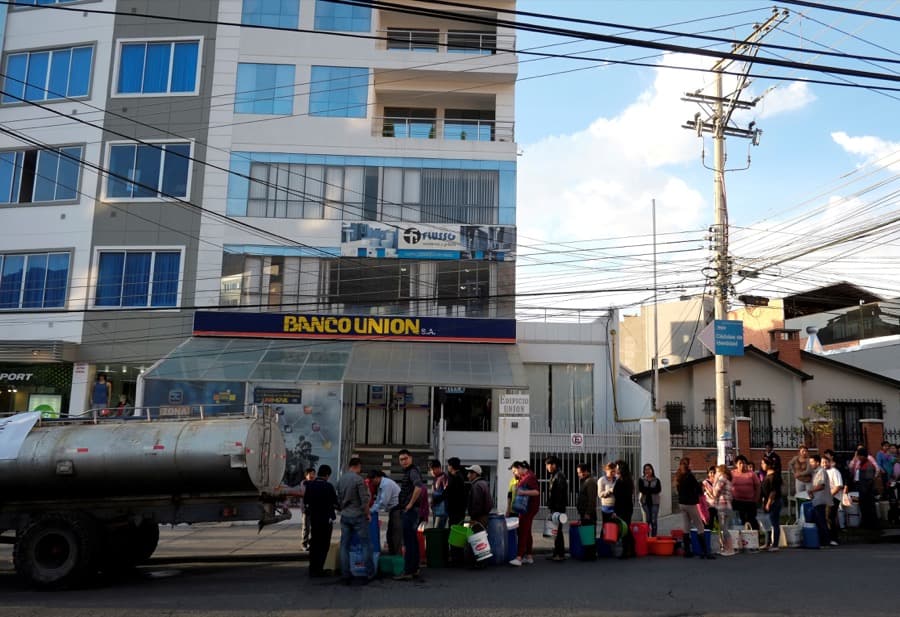 Bolivians stand in line to collect water from a truck in La Paz on Nov. 23.