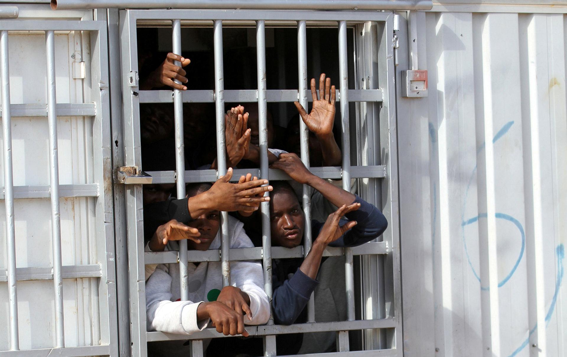 Migrants detained after trying to get to Europe wait in a detention camp in Gheryan, outside Tripoli, Libya