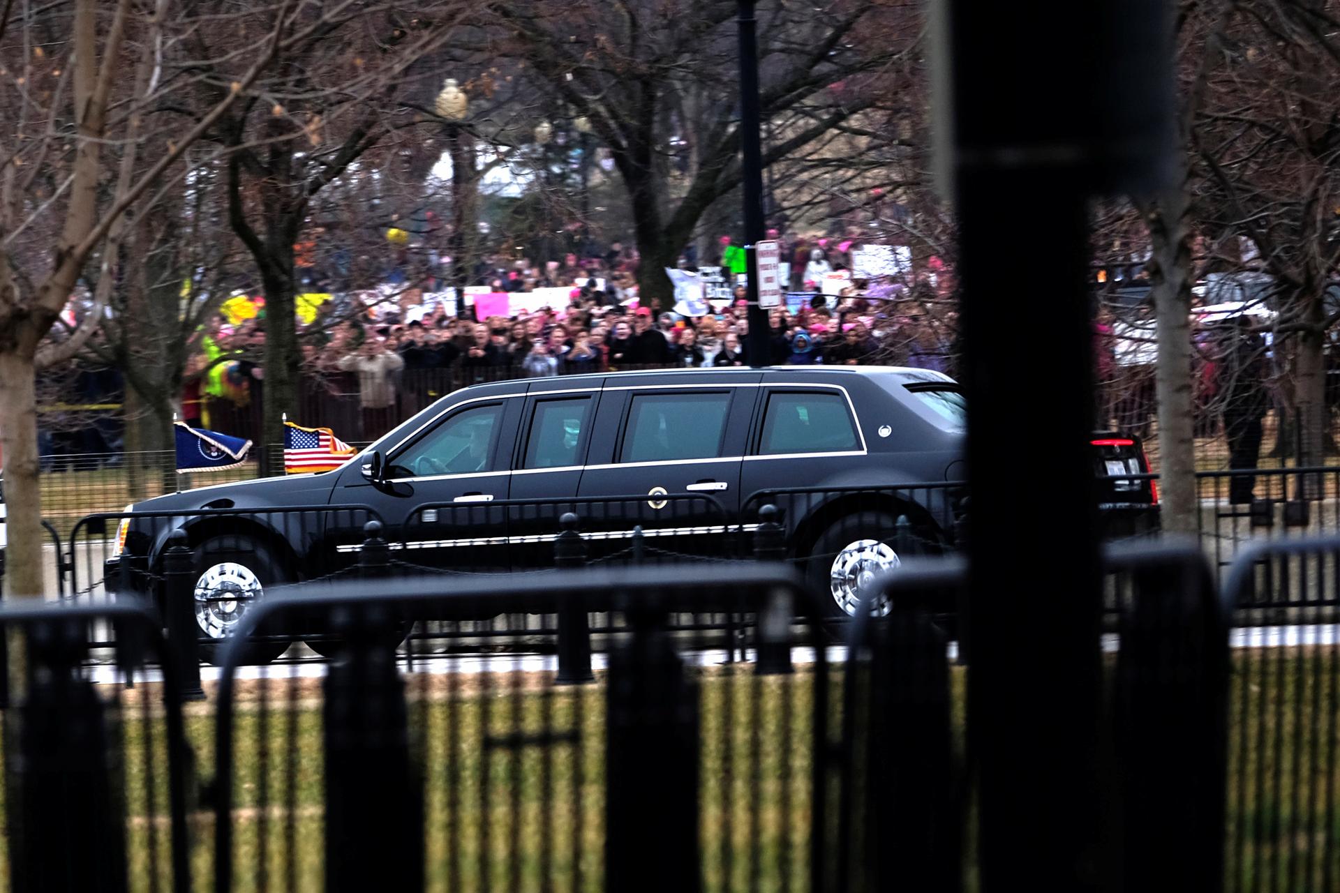 Protesters participating in the Women's March on Washington react as US President Donald Trump returns to the White House in Washington January 21, 2017.