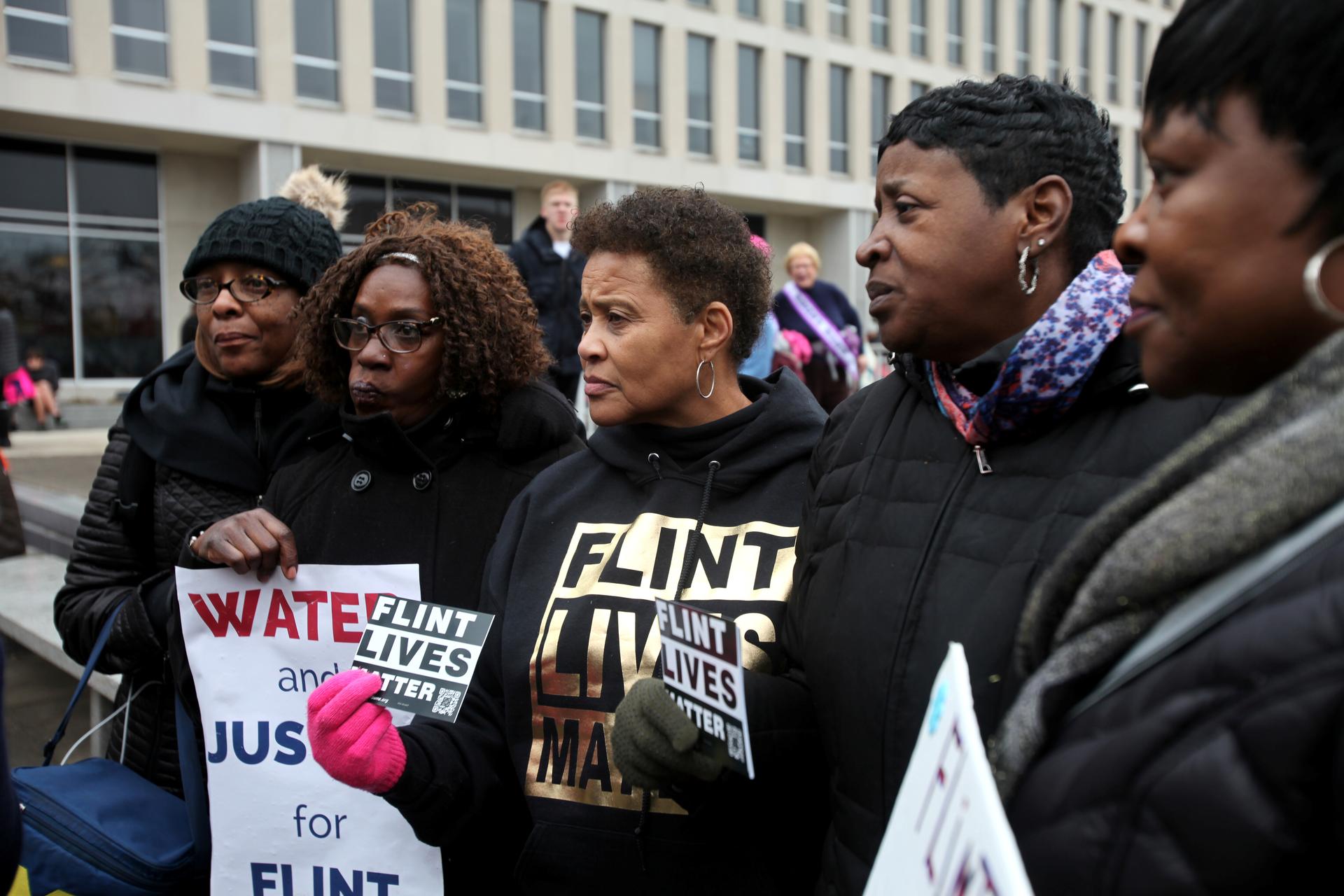 Women who said they chartered a bus from their home in Flint, Michigan, speak to media at the Women's March