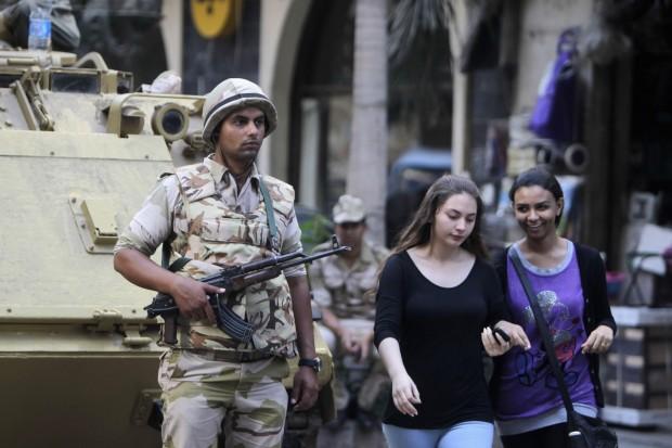 A soldier stands next to an armored personnel carrier near Tahrir Square, Cairo. An uneasy calm has returned to Egypt, but there are fears of renewed violence. (Photo: REUTERS/Mohamed Abd El Ghany)