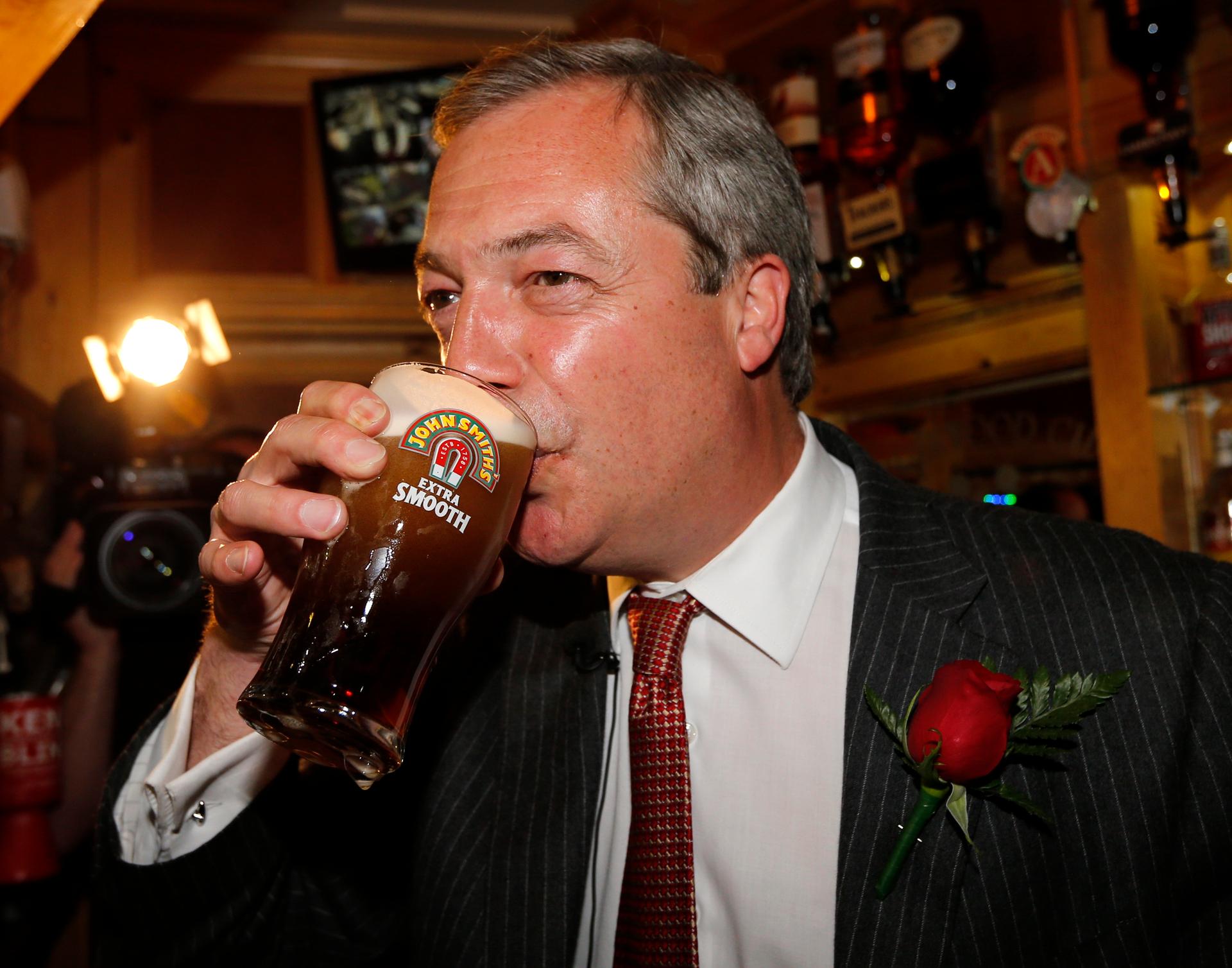 United Kingdom Independence Party (UKIP) leader Nigel Farage enjoys a pint of beer during a visit to mark St George's day at the Northwood Club in Ramsgate, southern England, April 23, 2015