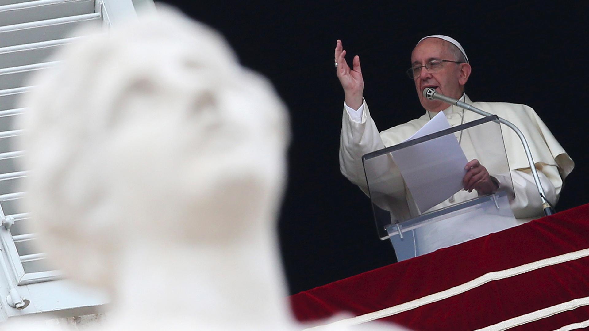 Pope Francis blesses the crowd gathered during his Sunday Angelus prayer on the feast of the Assumption.