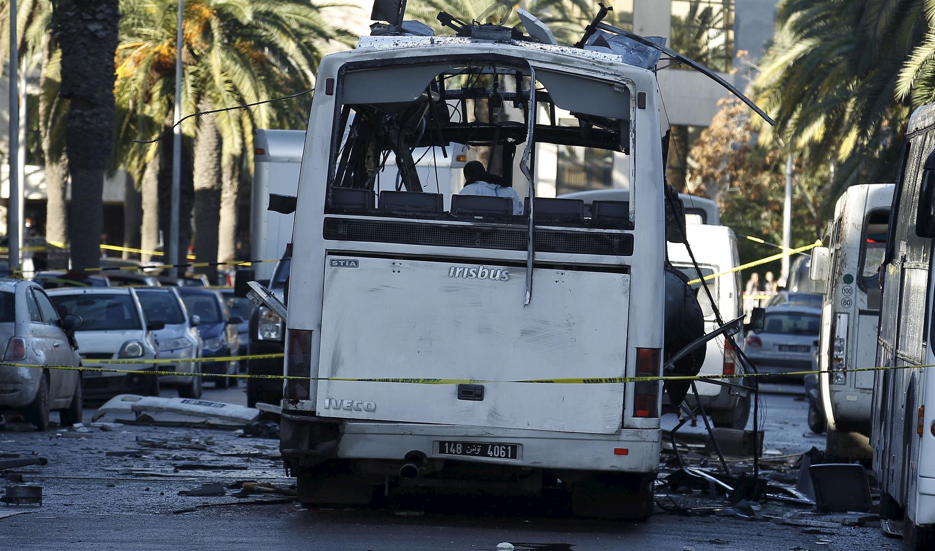 Tunisian forensics police inspect a Tunisian presidential guard bus at the scene of a suicide bomb attack in Tunis, Tunisia November 25, 2015.