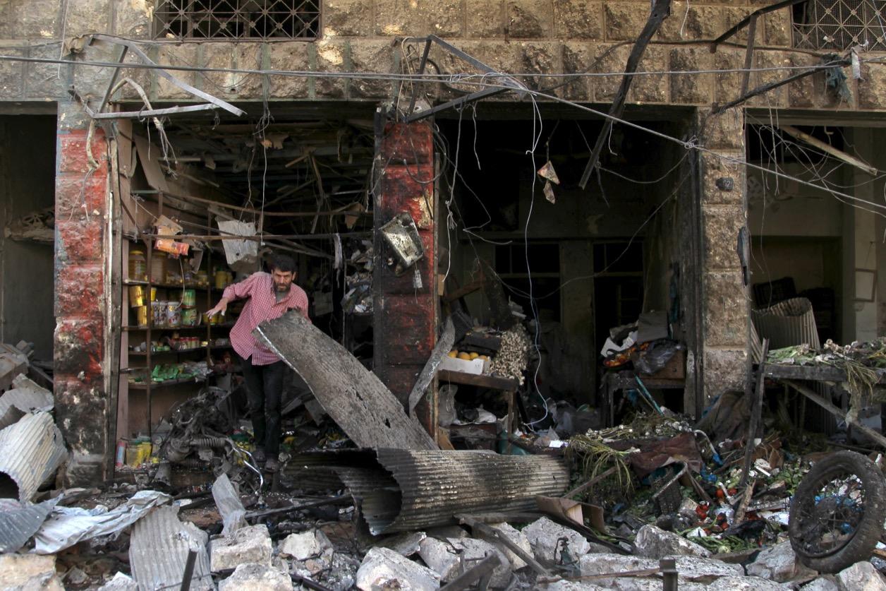 A man inspects damaged shops after an airstrike on a market in the town of Maarat al-Numan in the insurgent stronghold of Idlib province, Syria on April 19, 2016.