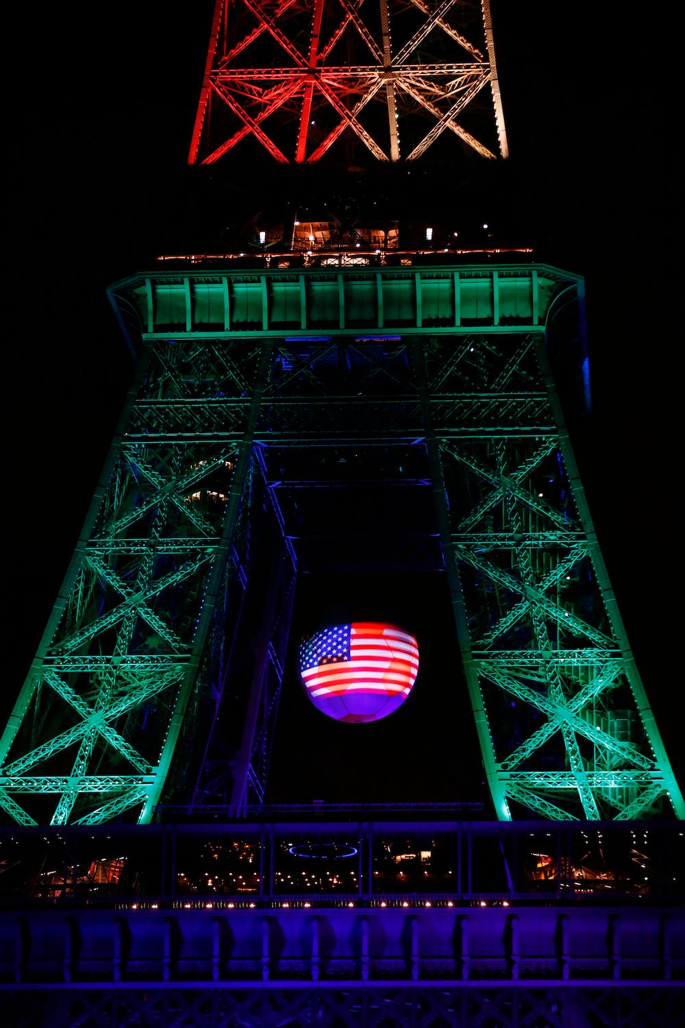 The American flag is projected onto the Eiffel Tower illuminated in memory of the victims of the nightclub mass shooting in Orlando on June 13.