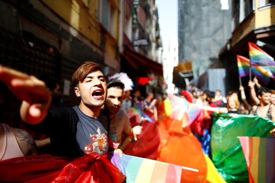 LGBT rights activists hold a rainbow flag during a transgender pride parade that was banned by the authorities in Istanbul on June 19.