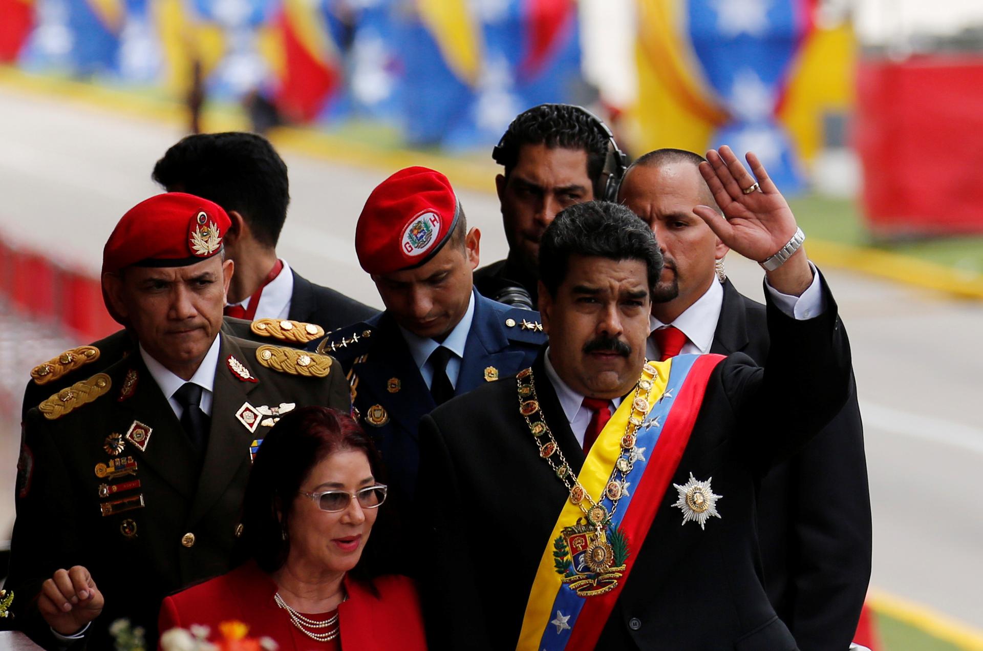 Venezuela's President Nicolas Maduro waves to the media next to his wife Cilia Flores after the military parade to celebrate the 205th anniversary of Venezuela's independence in Caracas, Venezuela July 5, 2016.