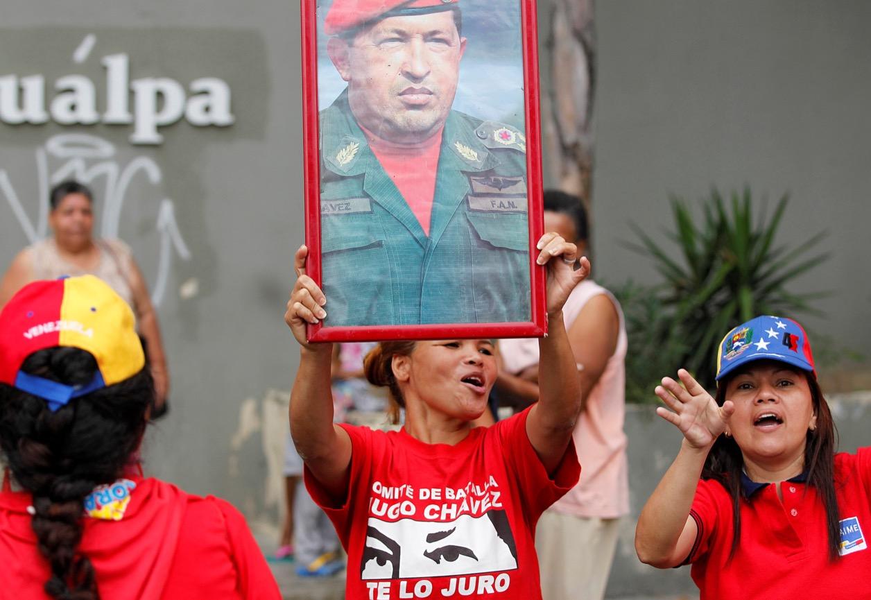 Government supporters hold a picture of late Venezuelan President Hugo Chavez on Sept. 1.
