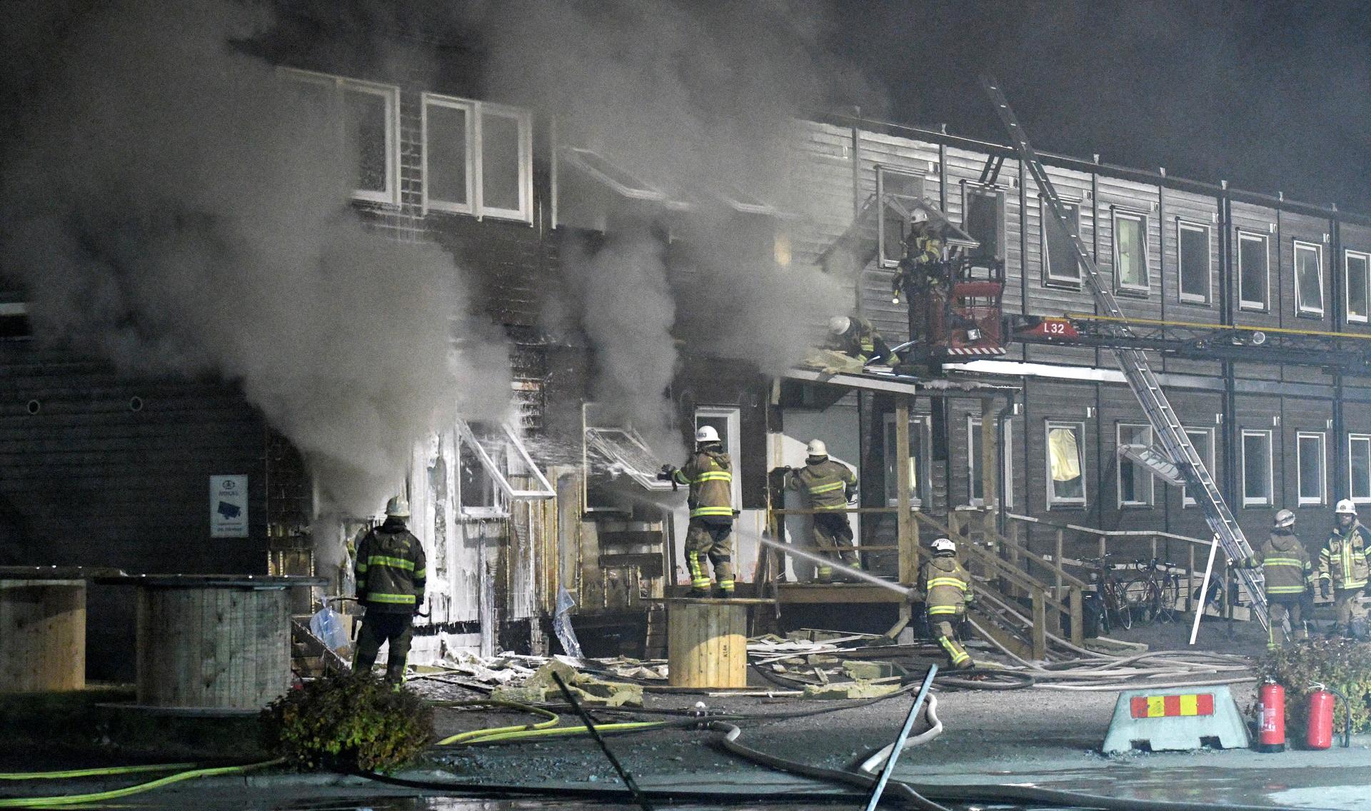 Firefighters extinguish a fire that broke out at a refugee center in Fagersjo, south of Stockholm, Sweden on the night of Oct. 16, 2016. Police suspected arson was the cause.