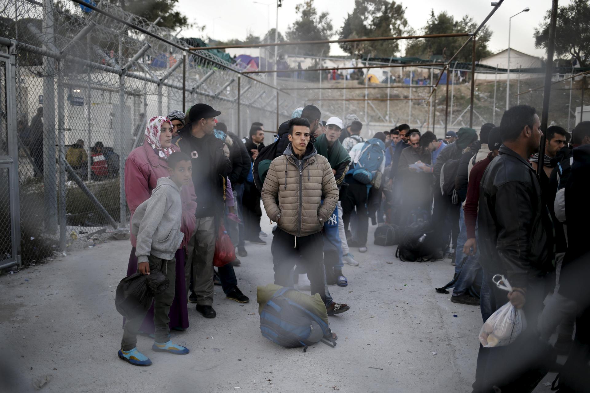 Refugees and migrants wait to be registered at the Moria refugee camp on the Greek island of Lesbos, November 5, 2015.