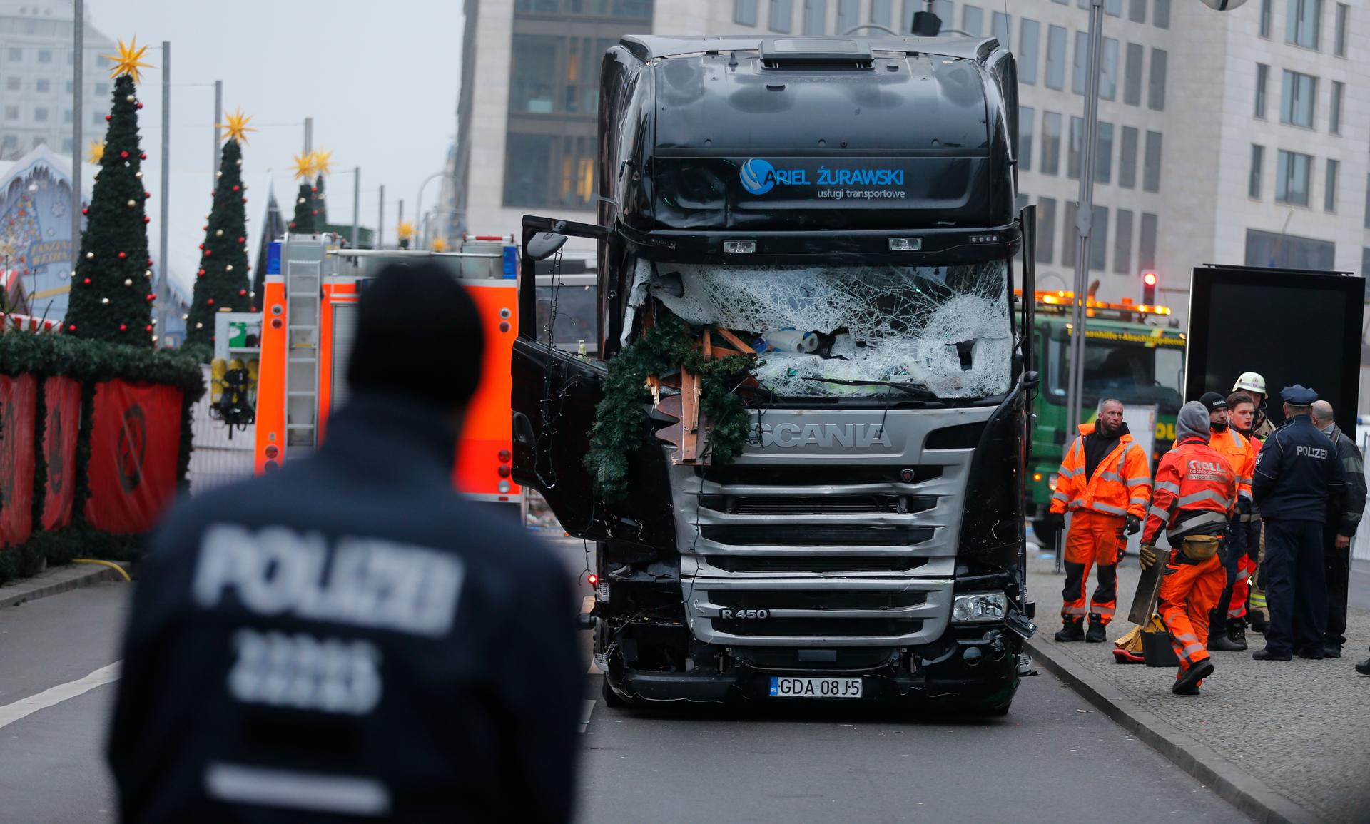 Police stand in front of the truck which ploughed last night into a crowded Christmas market in the German capital Berlin, Germany, December 20, 2016.