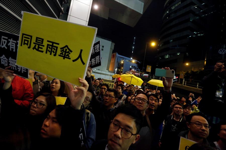 Pro-democracy protesters supporting Occupy Central movement demonstrate outside the police headquarters in Hong Kong, China March 27.