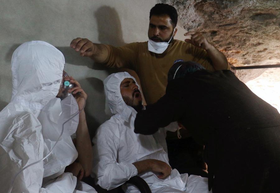 A man breathes through an oxygen mask as another one receives treatments, after what rescue workers described as a suspected gas attack in the town of Khan Sheikhoun in rebel-held Idlib, Syria April 4.