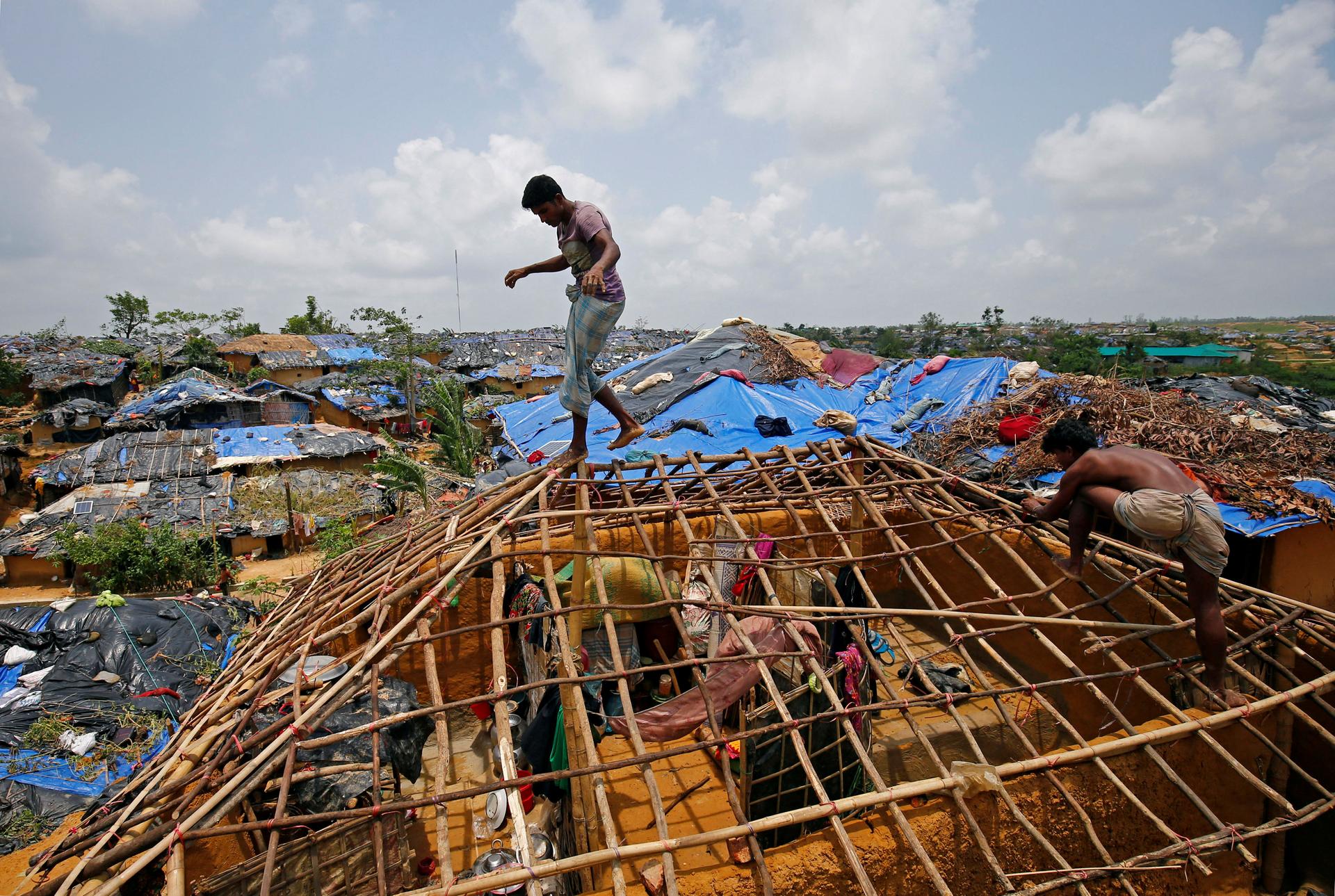 Rohingya refugees rebuild their home, which was destroyed by Cyclone Mora, at the Kutupalong makeshift refugee camp in Cox's Bazar, Bangladesh, June 1, 2017.