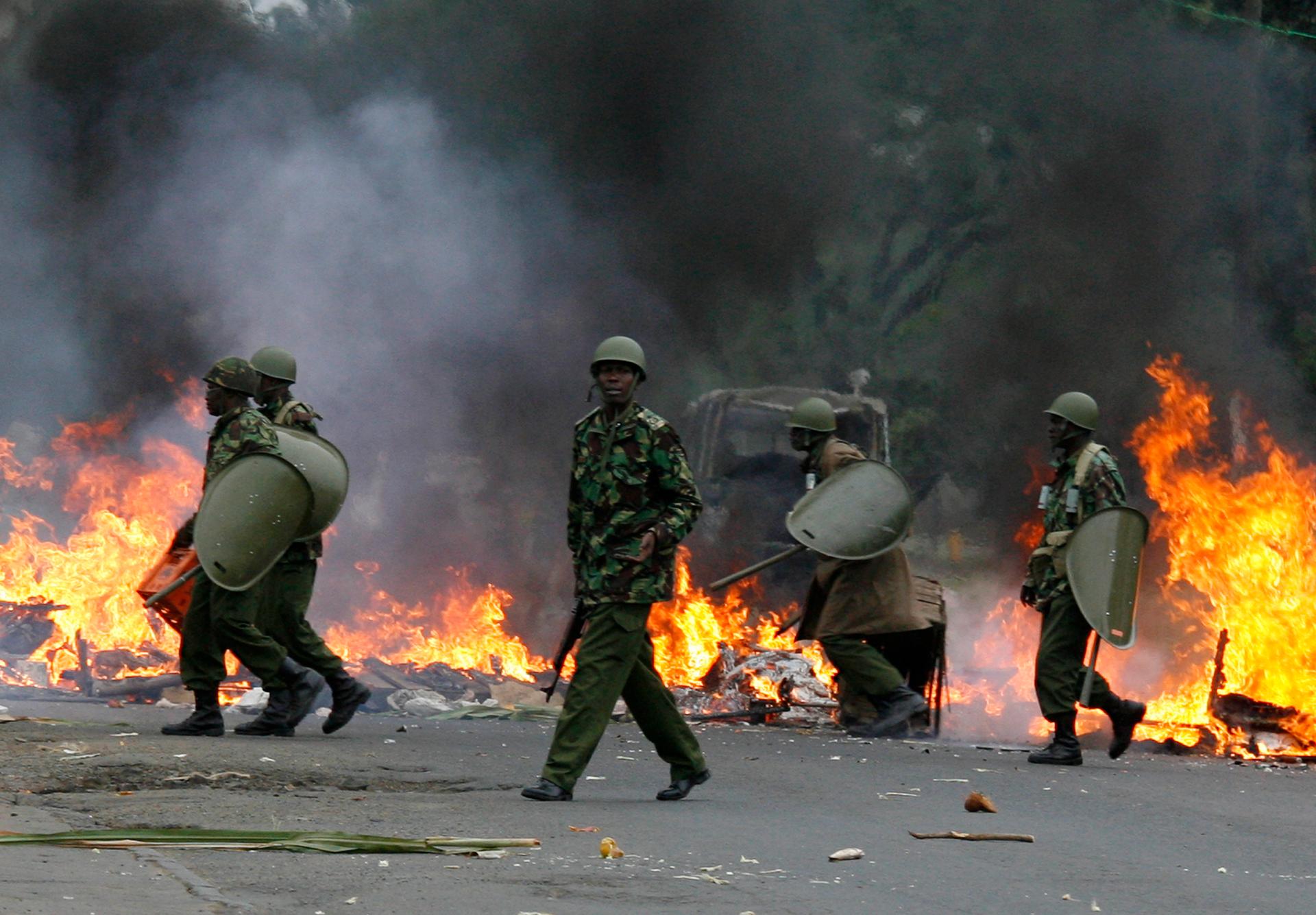 Riot police move to dismantle a burning roadblock in Nairobi December 31, 2007