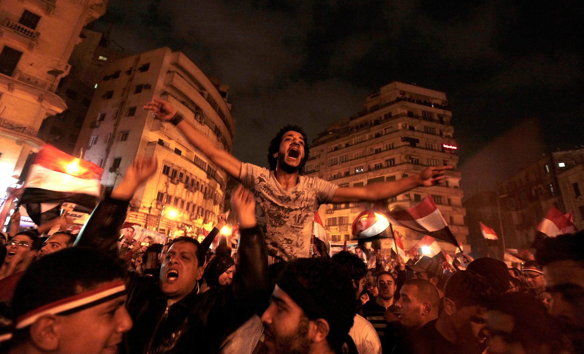 Anti-government protesters celebrate in Tahrir Square after the announcement of Egyptian President Hosni Mubarak's resignation in Cairo, Feb. 11, 2011.