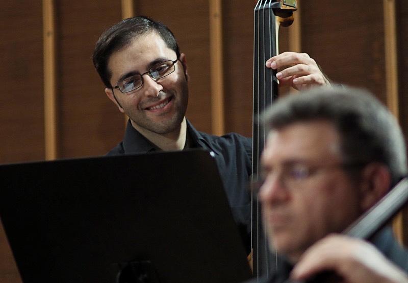 Raed Jazbeh playing double-bass with the Syrian Expat Philharmonic Orchestra.