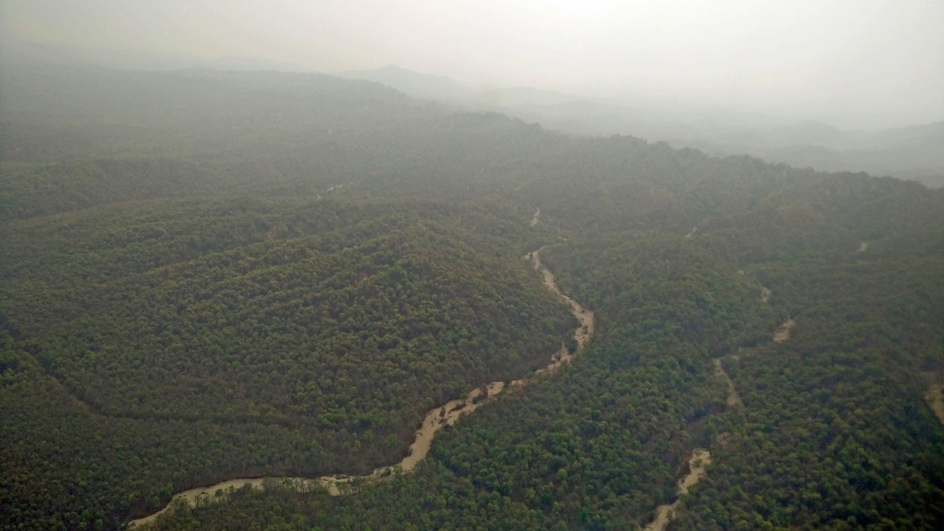 Smoke from forest fires hangs over dry mountain rivers near Dehradun, in the foothills of the Himalayas, in northern India.