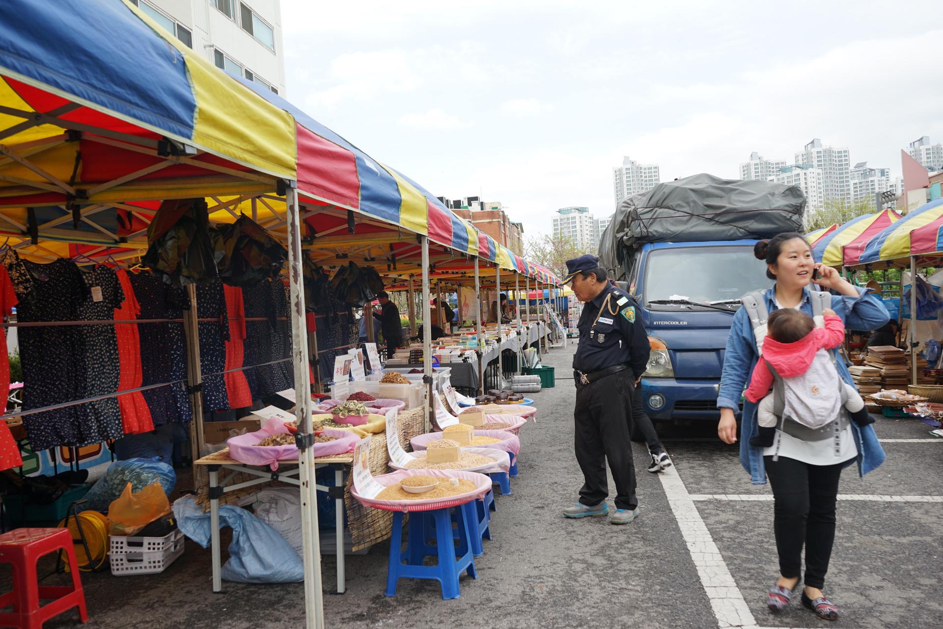 A police officer browses a South Korean market.  Danbi says many of the goods sold here can also be found in North Korean markets.