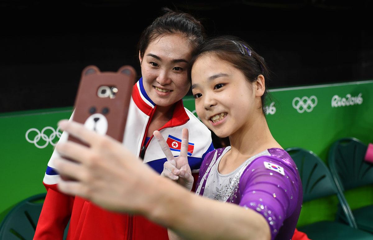 Lee Eun-Ju of South Korea (R) takes a selfie picture with Hong Un Jong of North Korea at the Rio Olympic Arena.