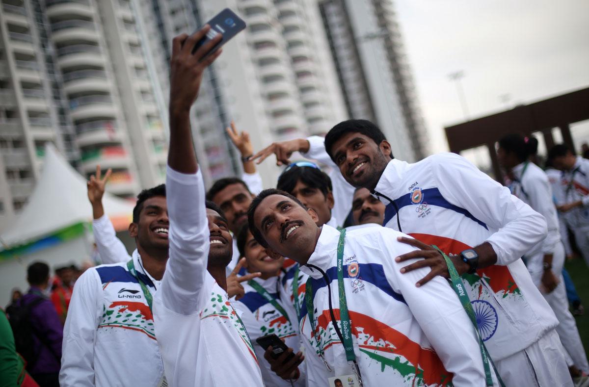 Members of the Indian delegation take a selfie during the welcome ceremony in the Olympic Village.